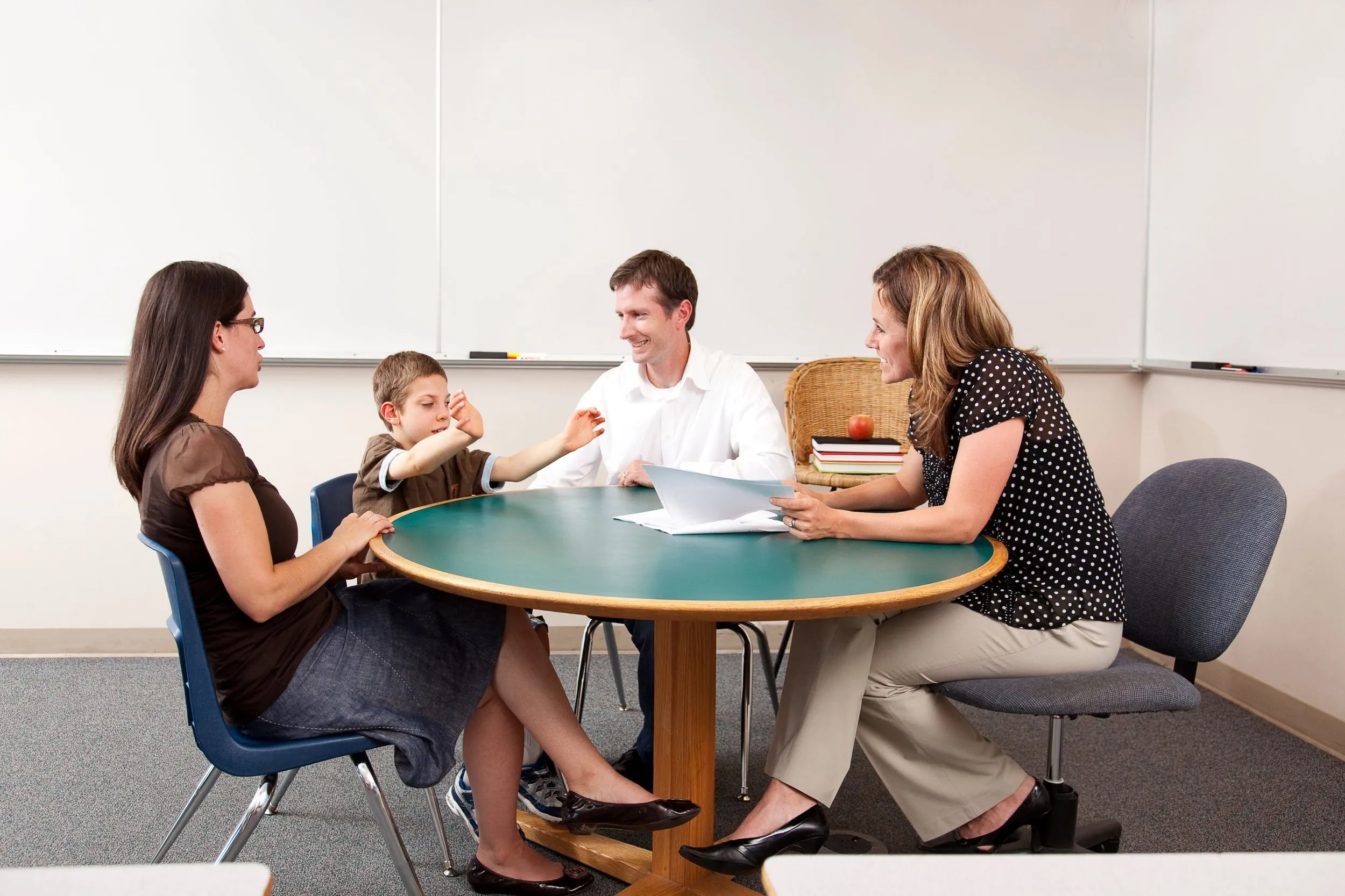 A family meeting with educators around a school conference table